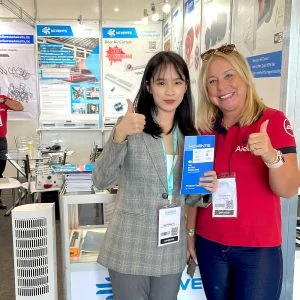 KCVENTS HVAC representative and customer at a ventilation equipment booth